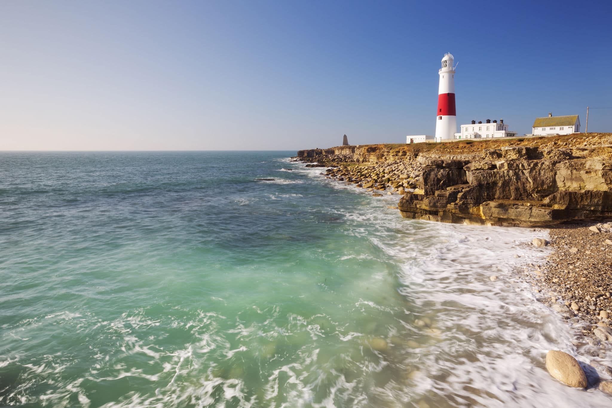 The Portland Bill Lighthouse on the Isle of Portland in Dorset, England on a sunny day.