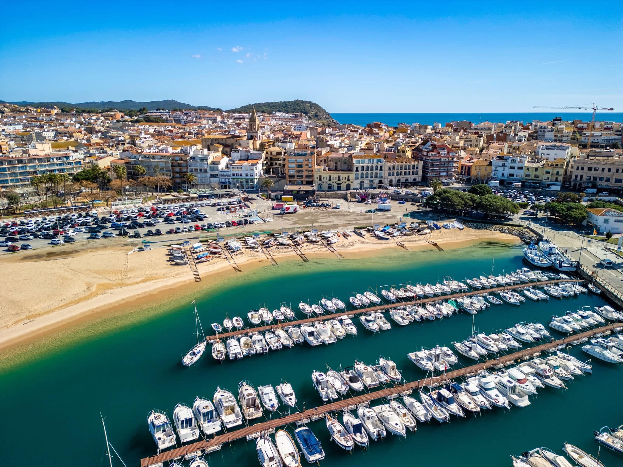 Aerial views reveal the charm of Palamos as a quintessential European tourism destination, with its blend of historic architecture and natural beauty.