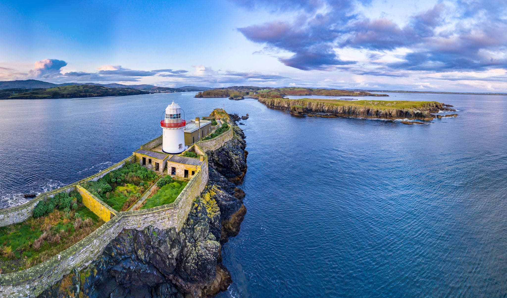 Aerial of the Rotten Island Lighthouse with Killybegs in background - County Donegal - Ireland.