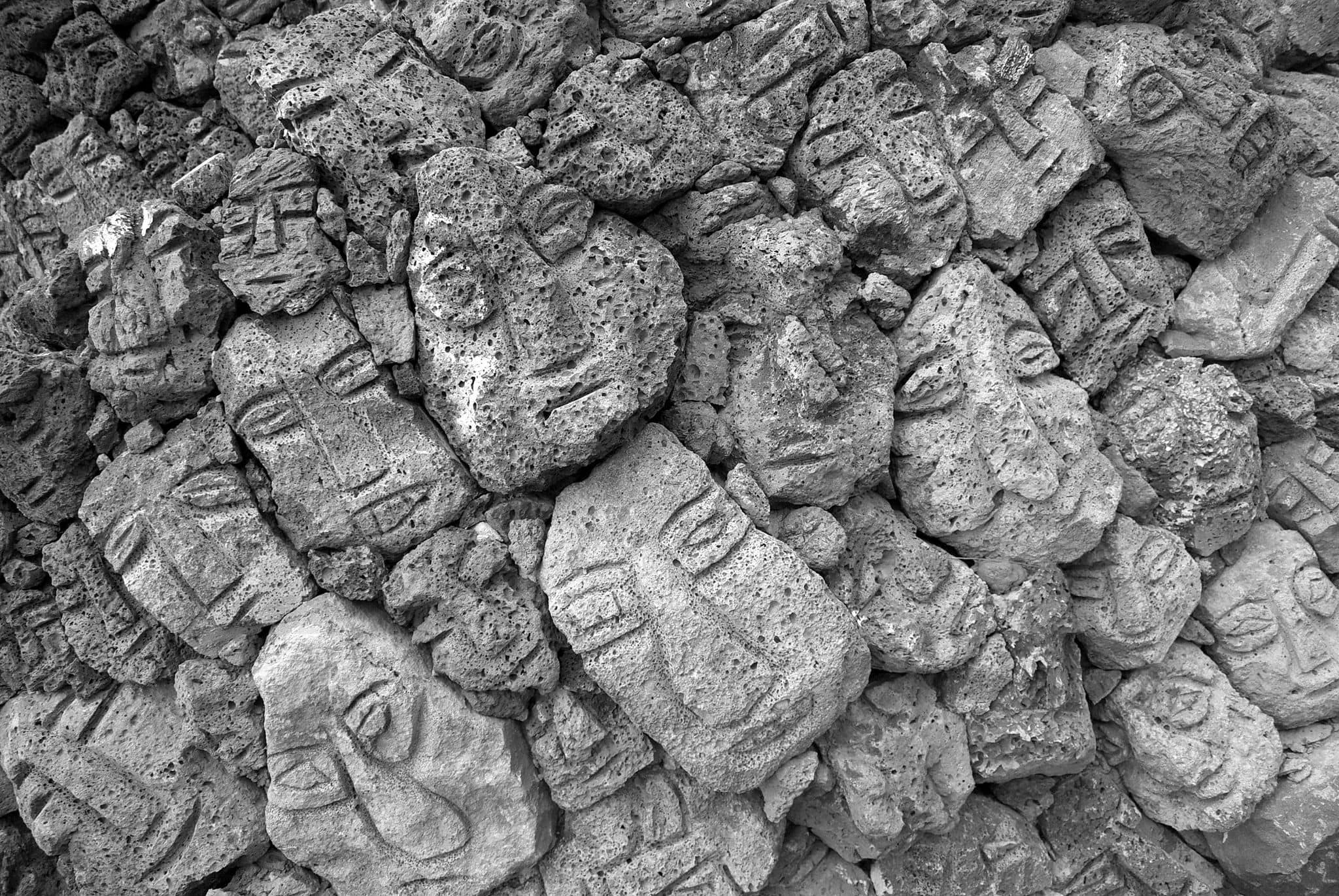 Stone faces in Keumrung Sculpture Park in Jeju, South Korea