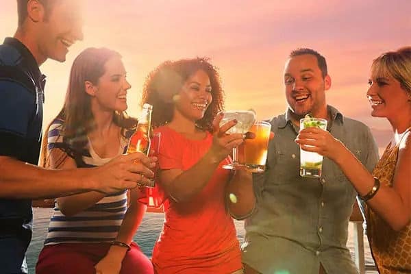 Friends having cocktails at sunset