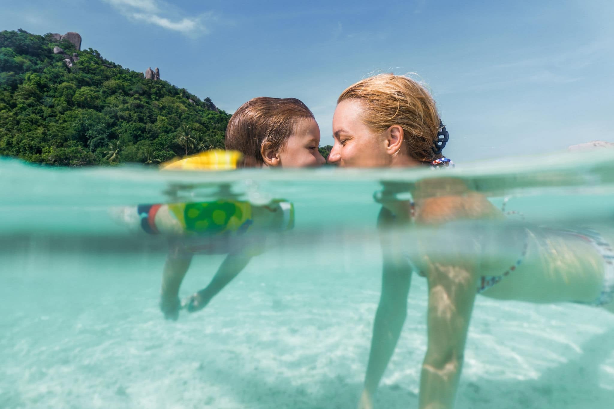 Affectionate mother and son enjoying in their love in the sea.