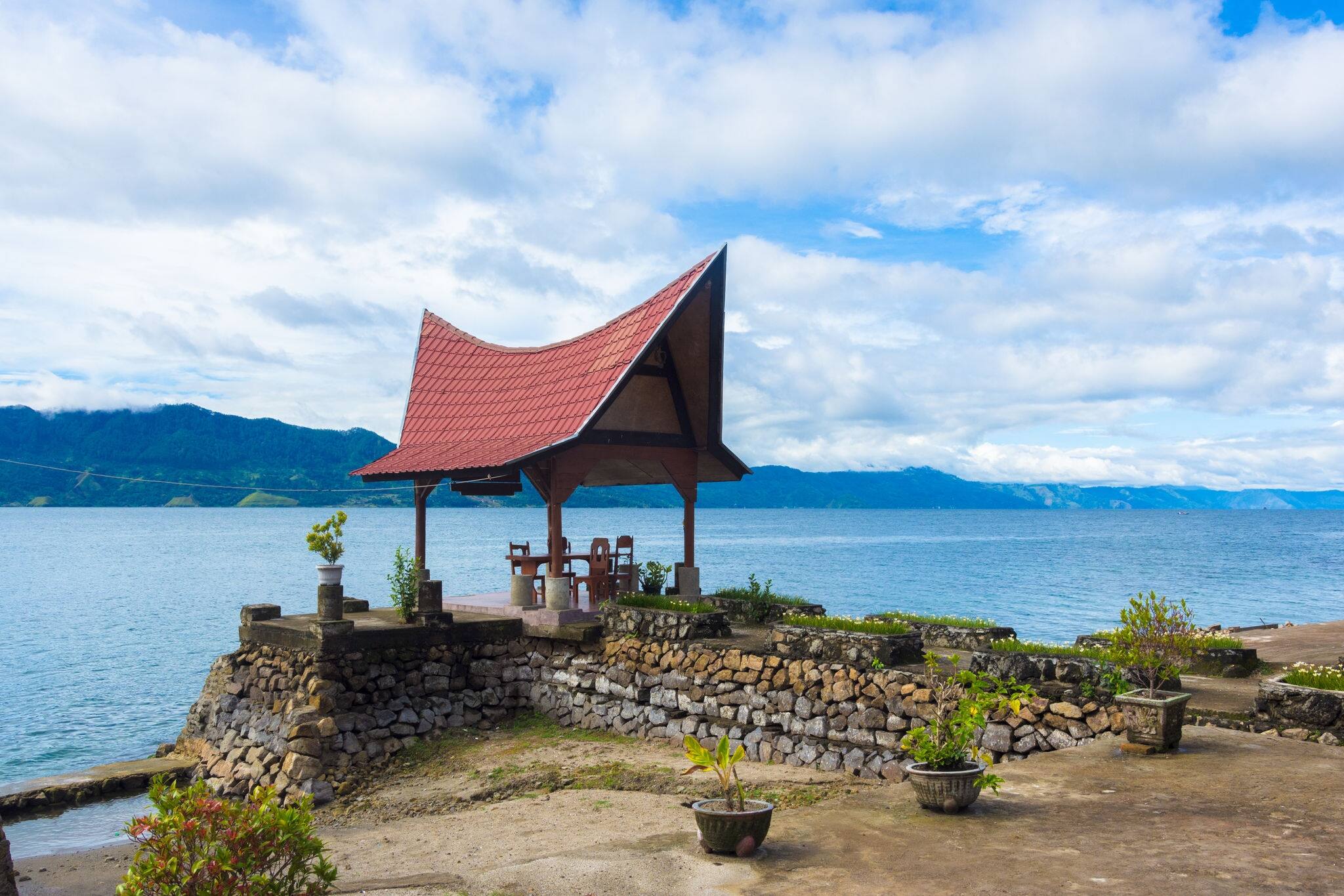 Beautiful view of traditional building and roof at Toba lake with blue sky background  from  Indonesia.