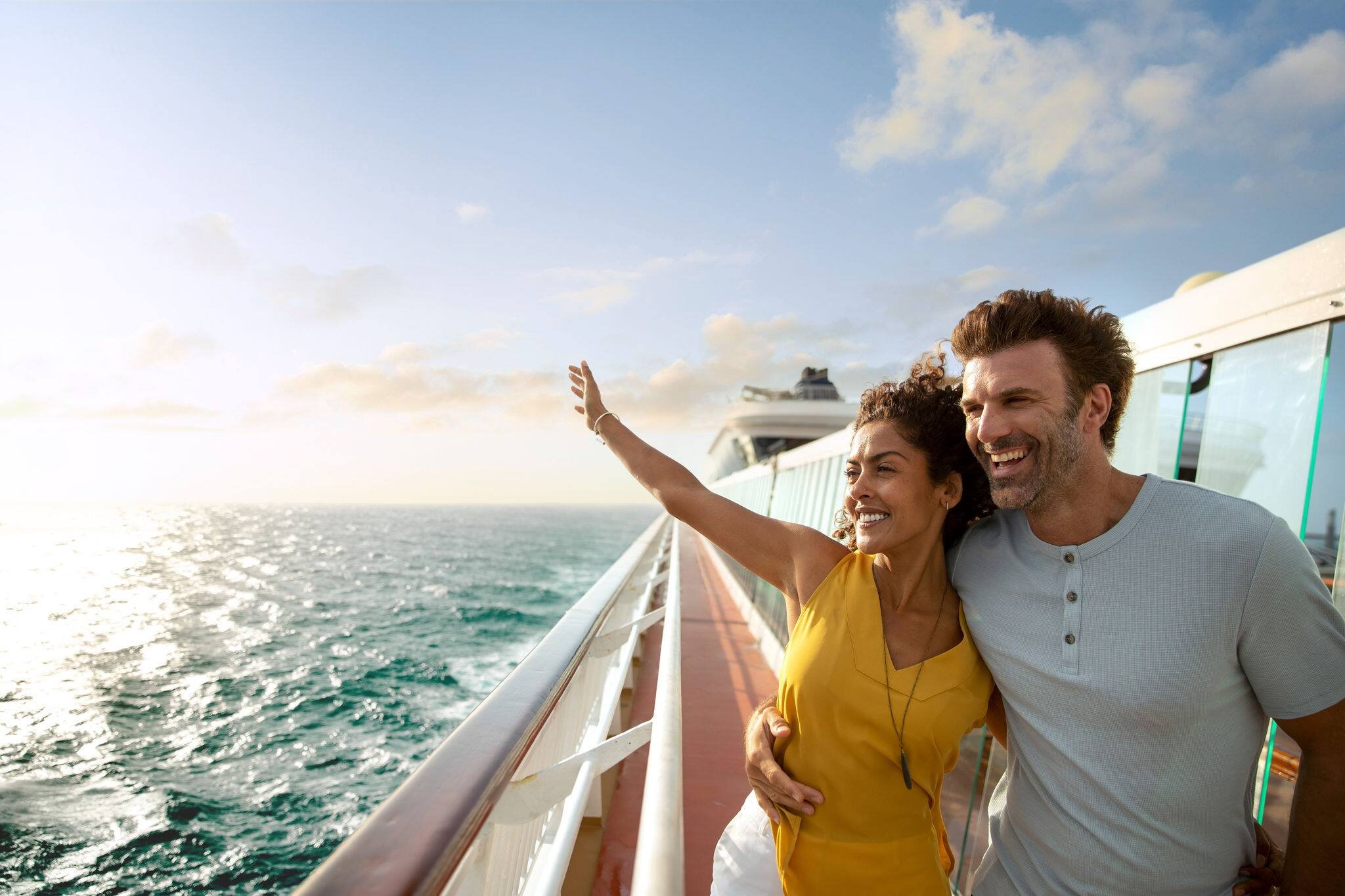 Couple waving at the sea