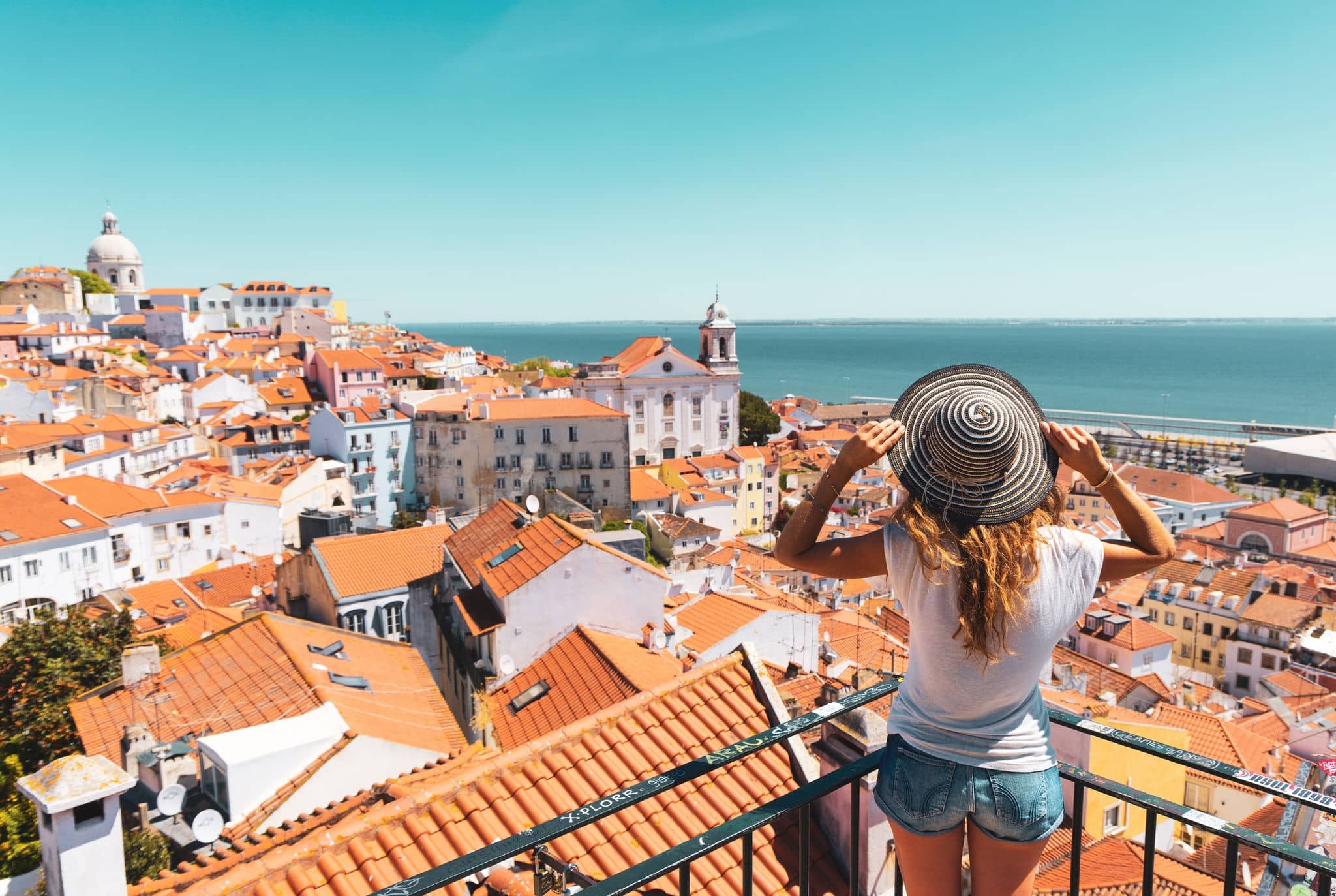 Traveler Woman, tourist on balcony looking at panoramic view of Lisboa- Tourism, vacation, travel in Portugal