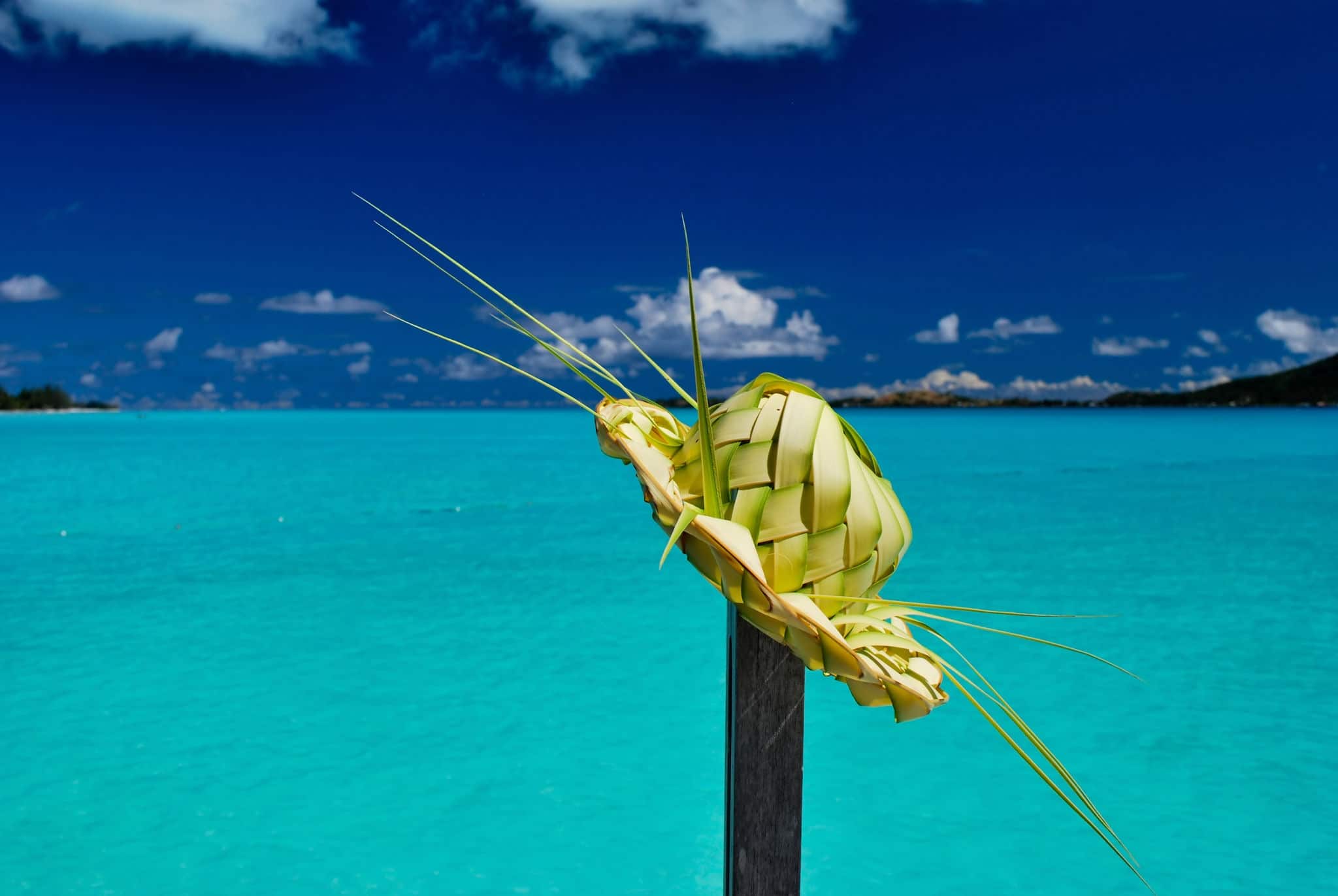 Palm hat against a turquoise blue lagoon in Bora Bora