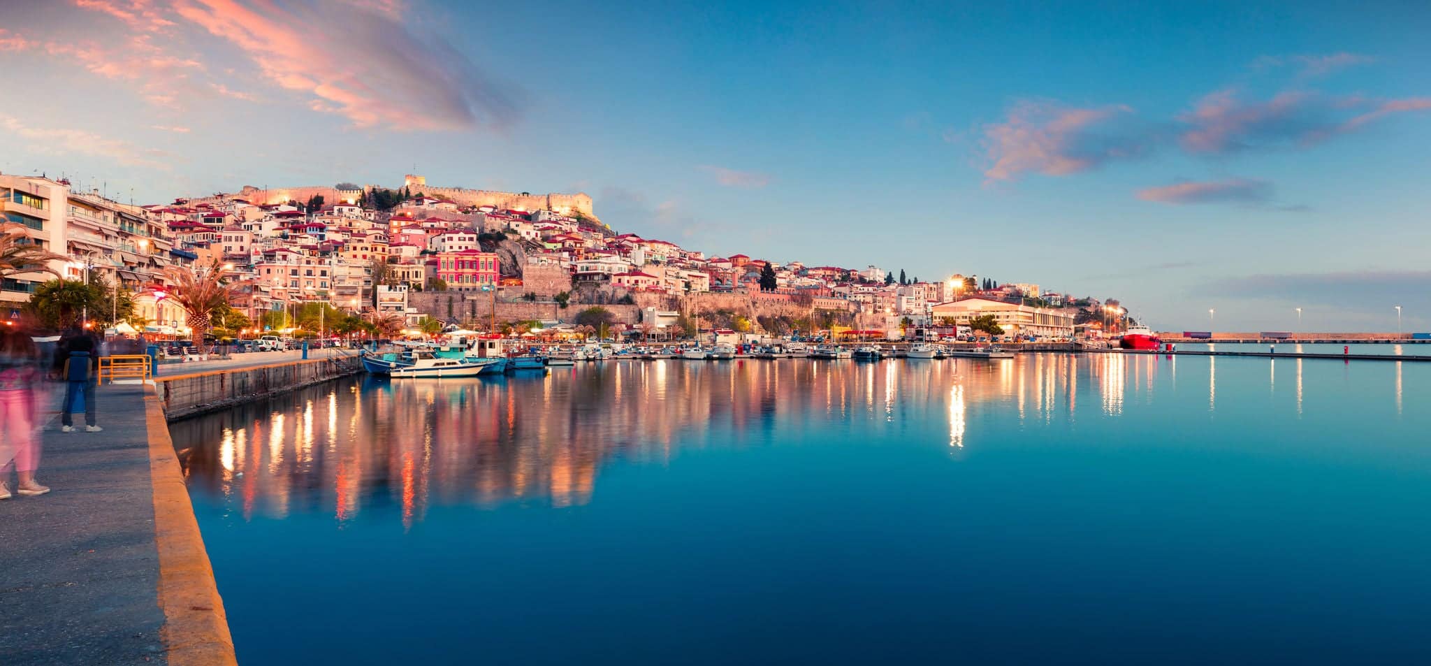 Beautiful spring seascape on Aegean Sea. Colorful evening panorama of Kavala city, the principal seaport of eastern Macedonia and the capital of Kavala regional unit. Greece, Europe.
