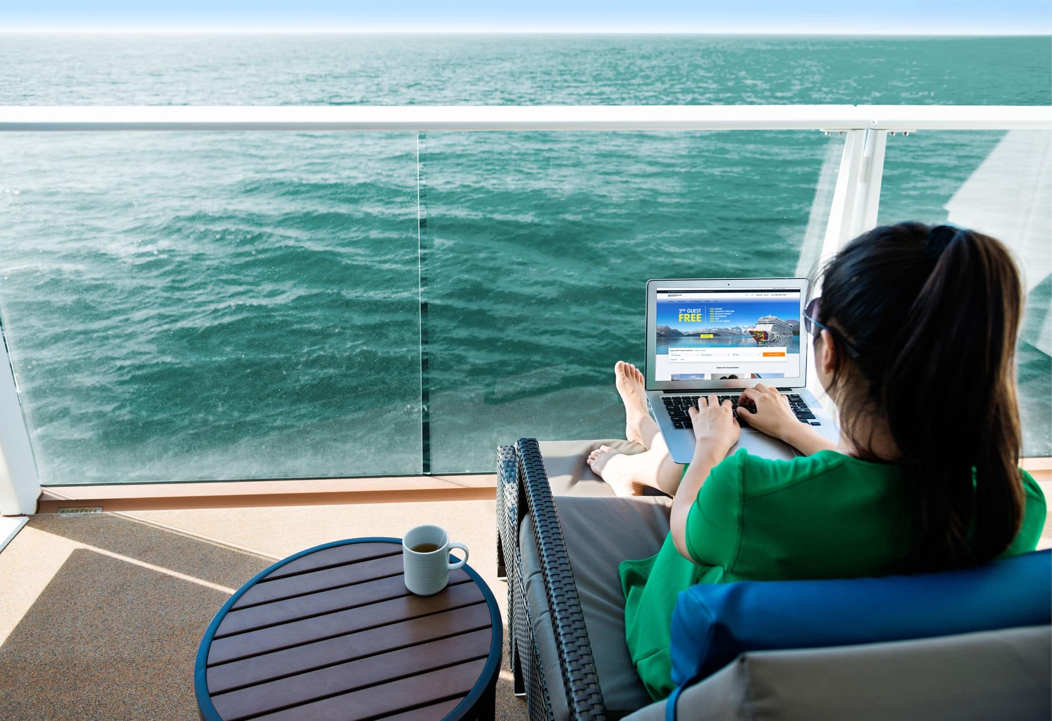 Woman working with a laptop on cruise ship.