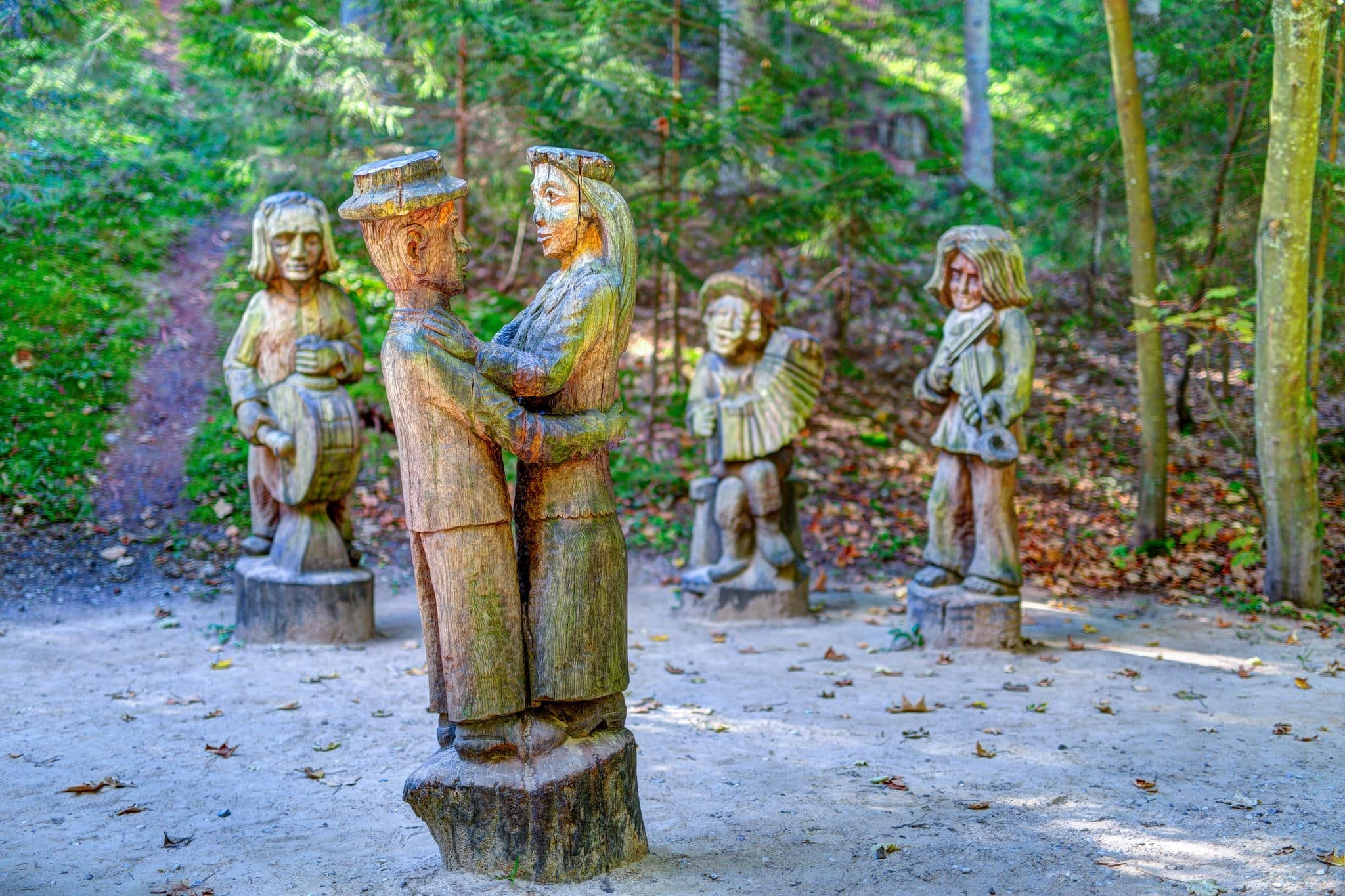 Old wooden sculptures in the forest. Witch Hill park, Lithuania.