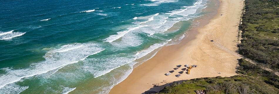 Aerial views of 75 Mile Beach highway on the sand island of K’gari, Queensland, Australia