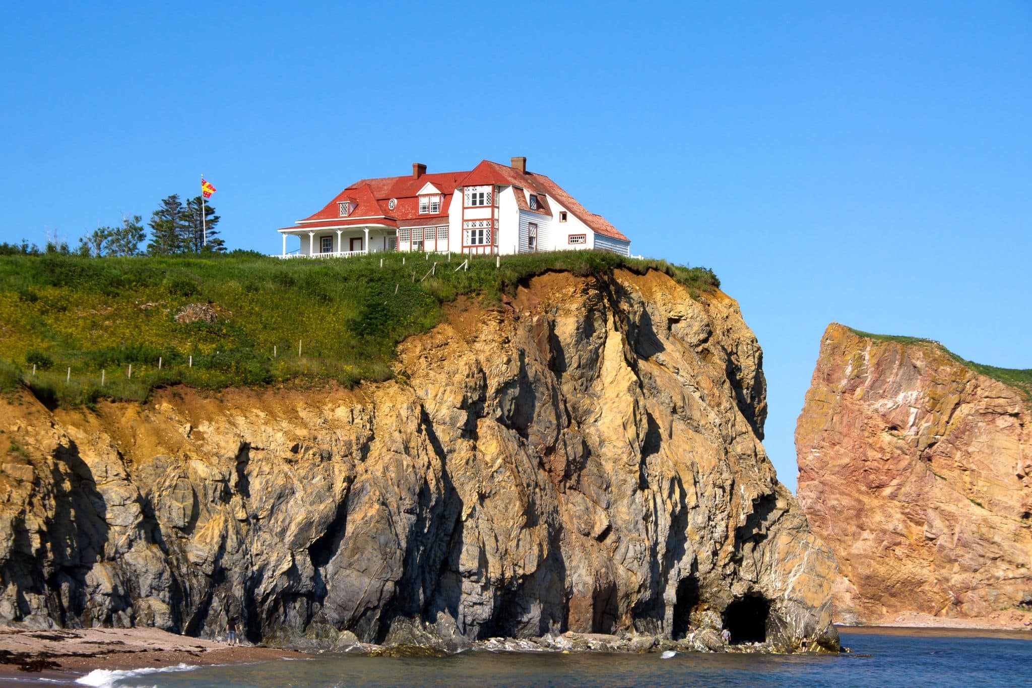 The Red House on top of the cliff on the edge of the water.Percé (City) Quebec, Canada
