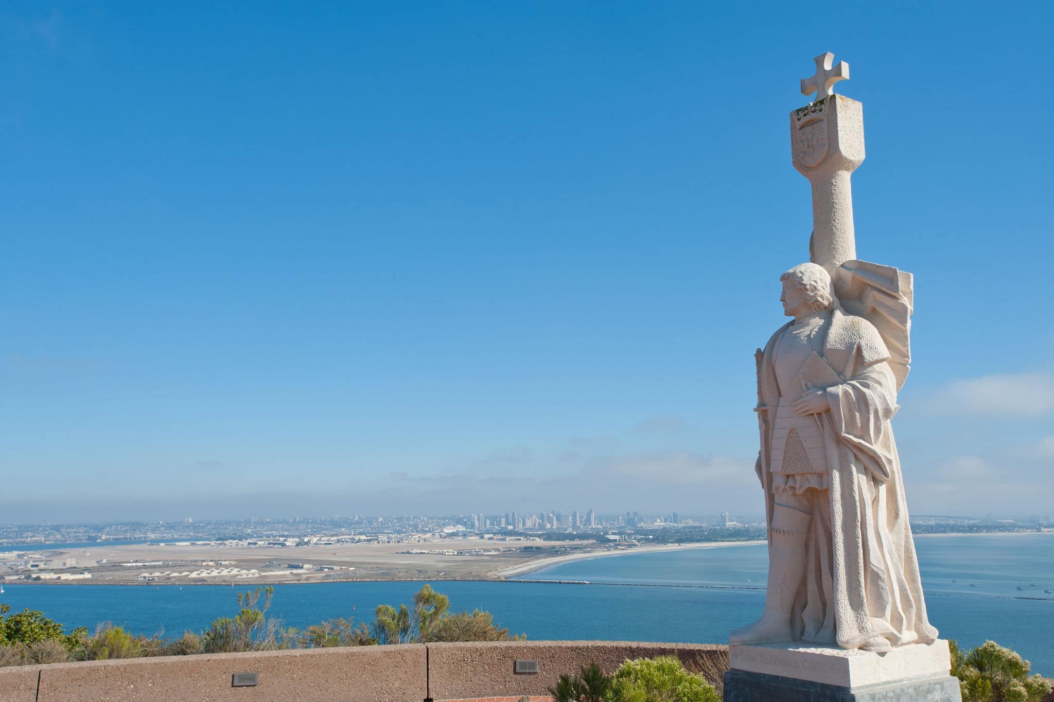 Juan Rodri­guez Cabrillo statue and panorama of San Diego, California
