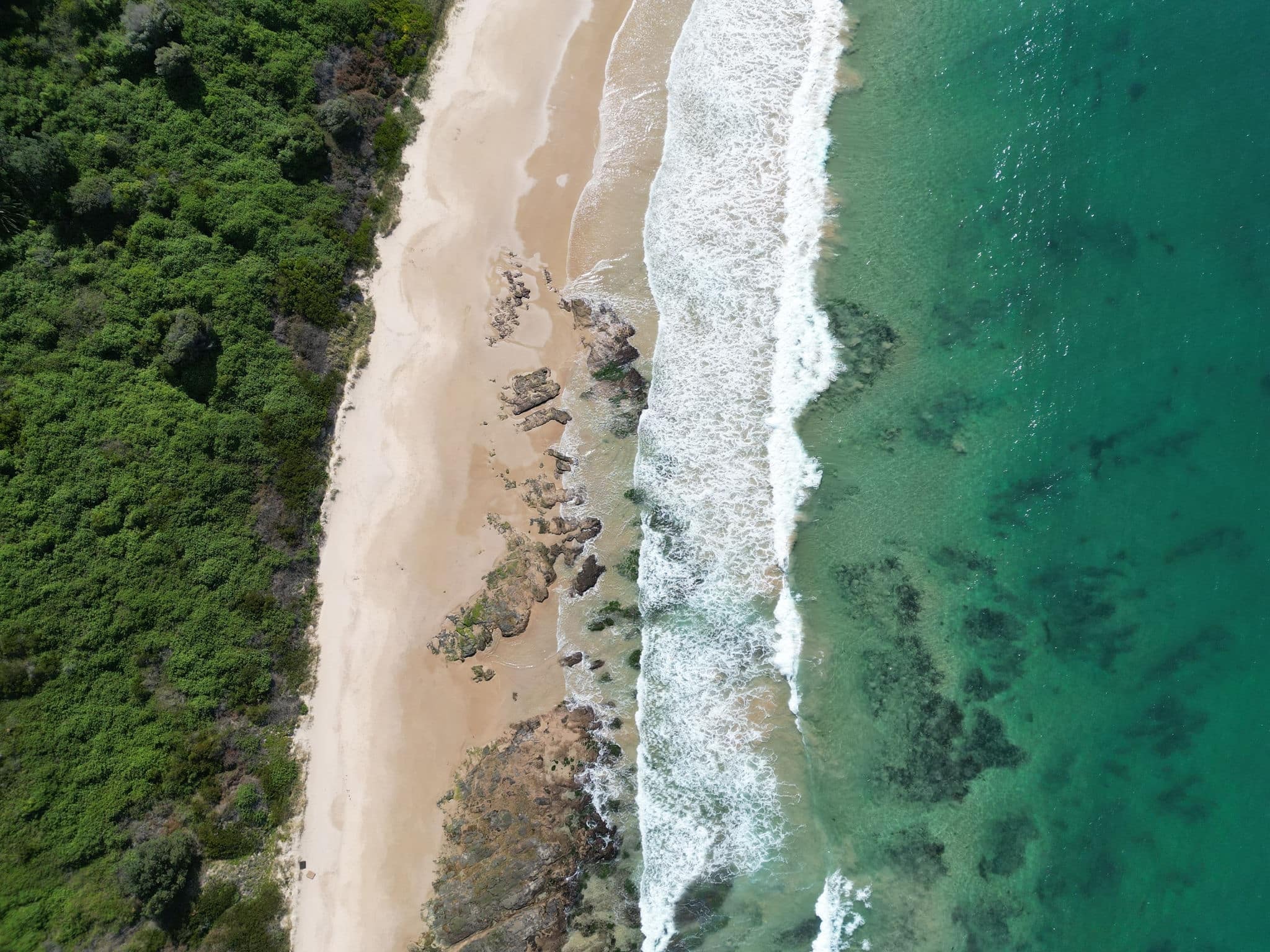 Ariel shot of  waves and landscape of MM beach from Hill 60, port Kembla, Illawarra, New South Wales, Australia