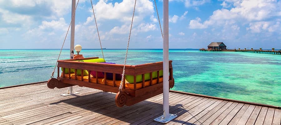 Swinging chair hammock facing beach oceanfront.