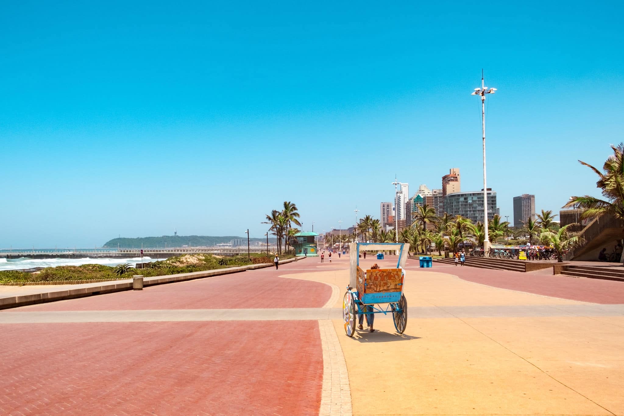 Promenade of Durban bay of plenty  with traditional rickshaw driving on it