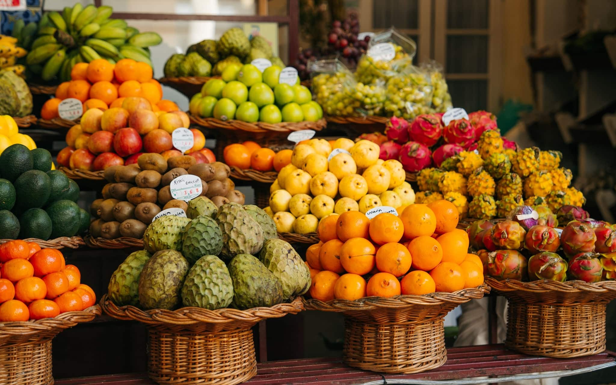 Fresh and ripe exotic fruits on traditional farmer market Mercado dos Lavradores, Funchal, Madeira island, Portugal