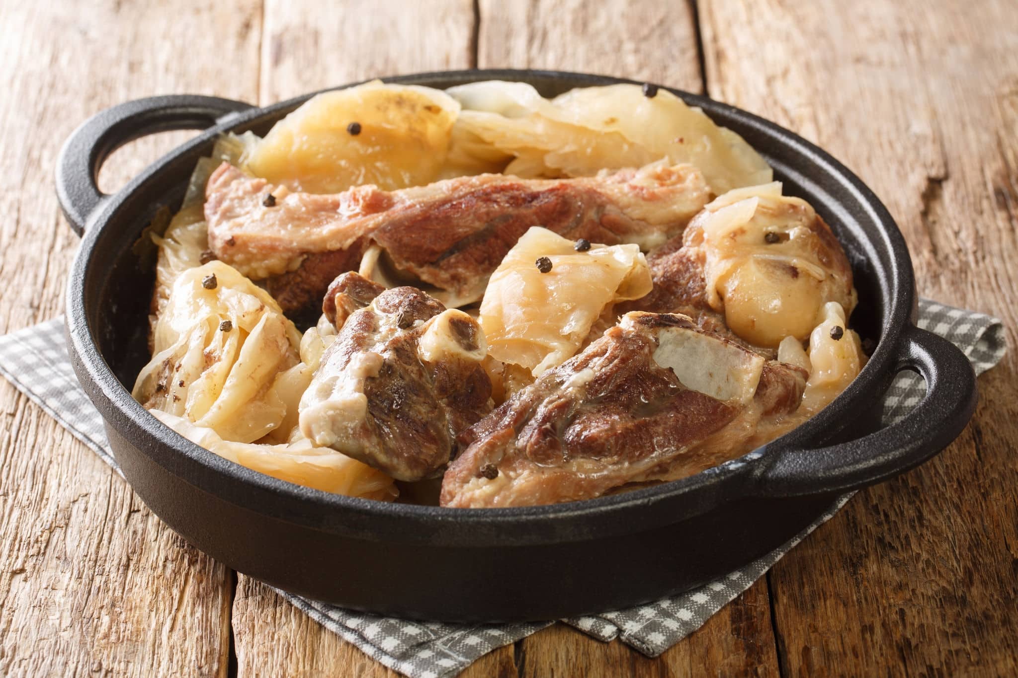 Farikal, or Lamb and Cabbage, is an old, traditional Norwegian dish closeup in a pan on the table. Horizontal