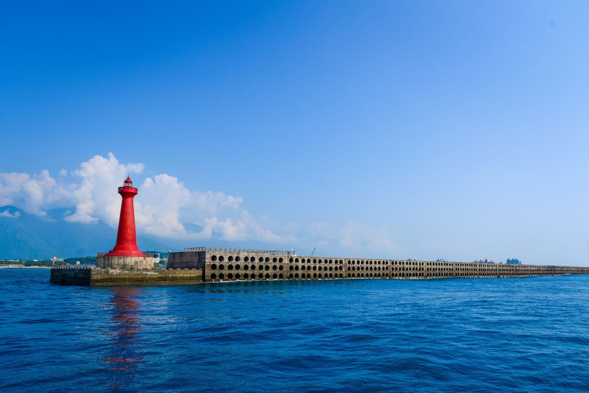 The Red Lighthouse of Hualien Harbor and The Pacific Ocean. A Landmark of Hualien city, Taiwan.