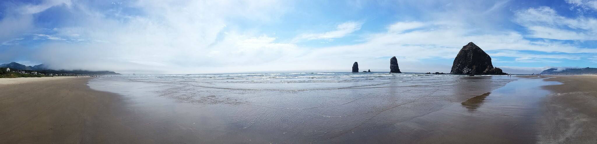Panoramic view of Haystack Rock and Cannon Beach near Astoria, Oregon on a summer's day