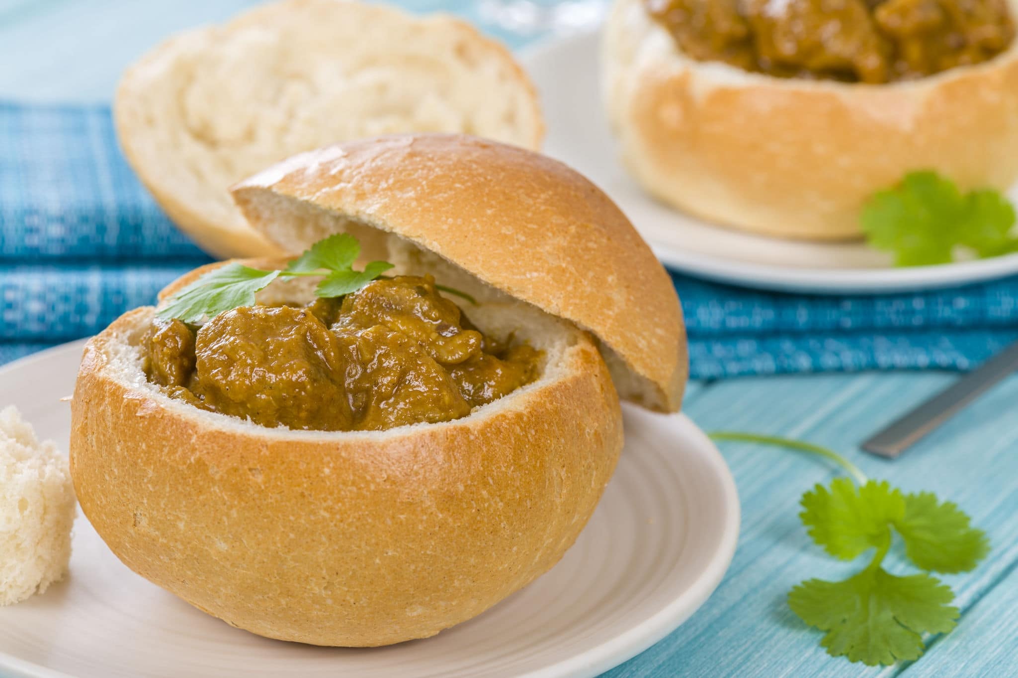 Bunny Chow - South African mutton curry served inside a hollow bread bun.