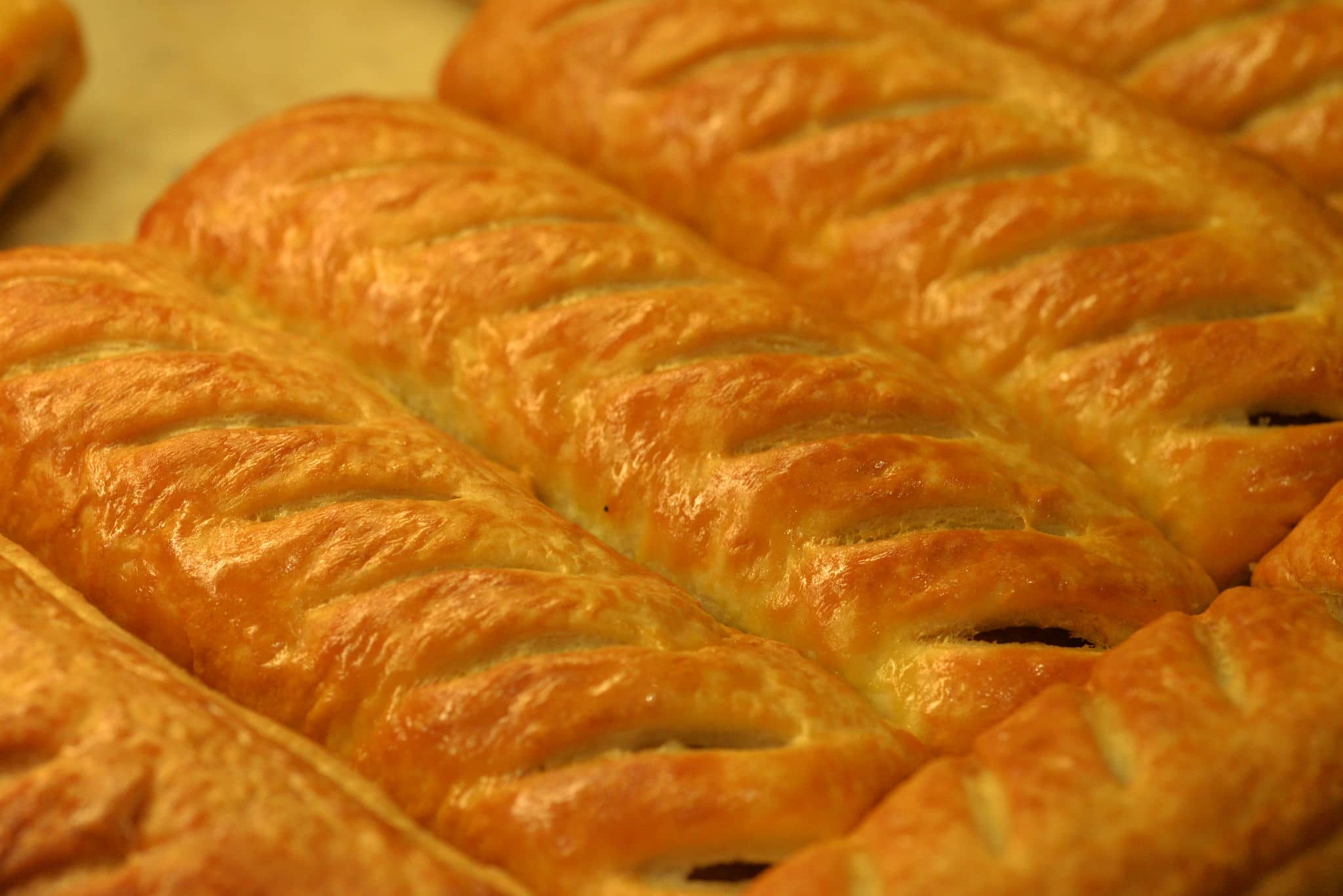 Freshly baked greggs sausage rolls in a shop window