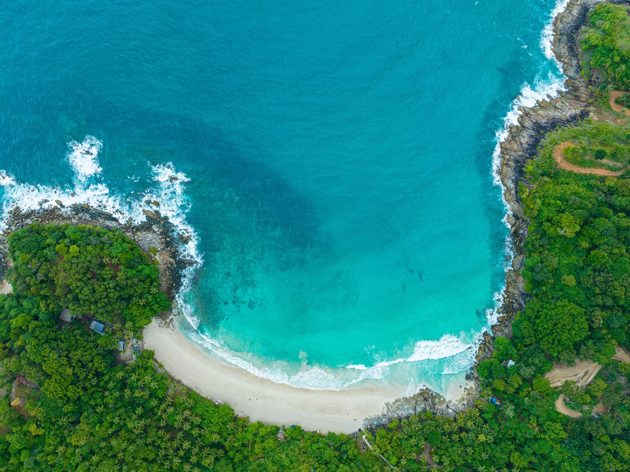 Aerial view of an amazing beach with small white waves.