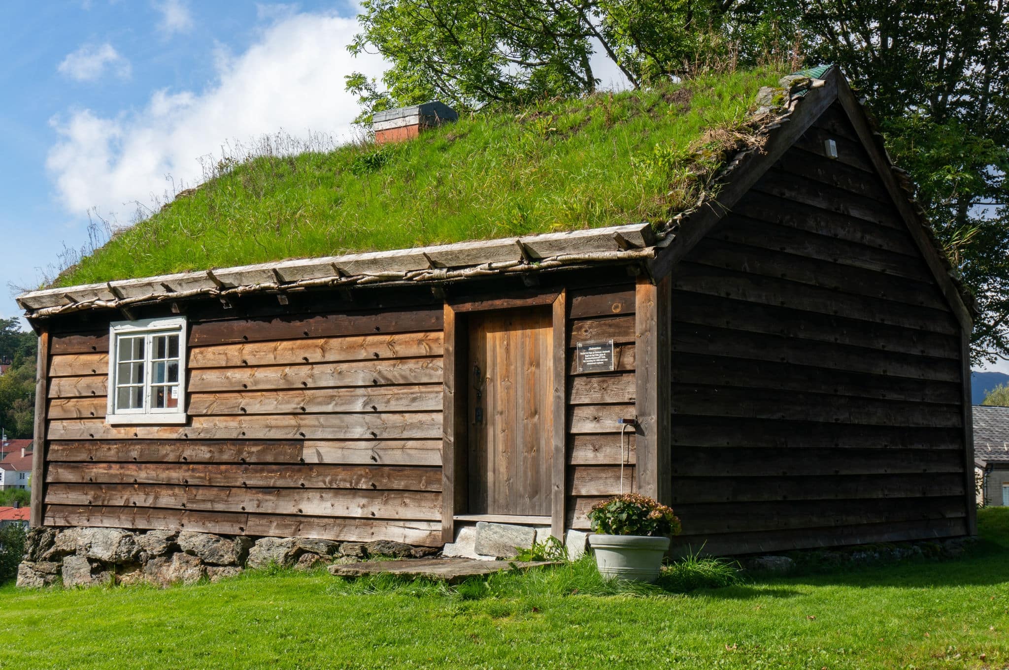 Leirvik, Norway - September 3 2019: Typical old wooden building, roof covered with green grass. Island of Stord, Vestland.