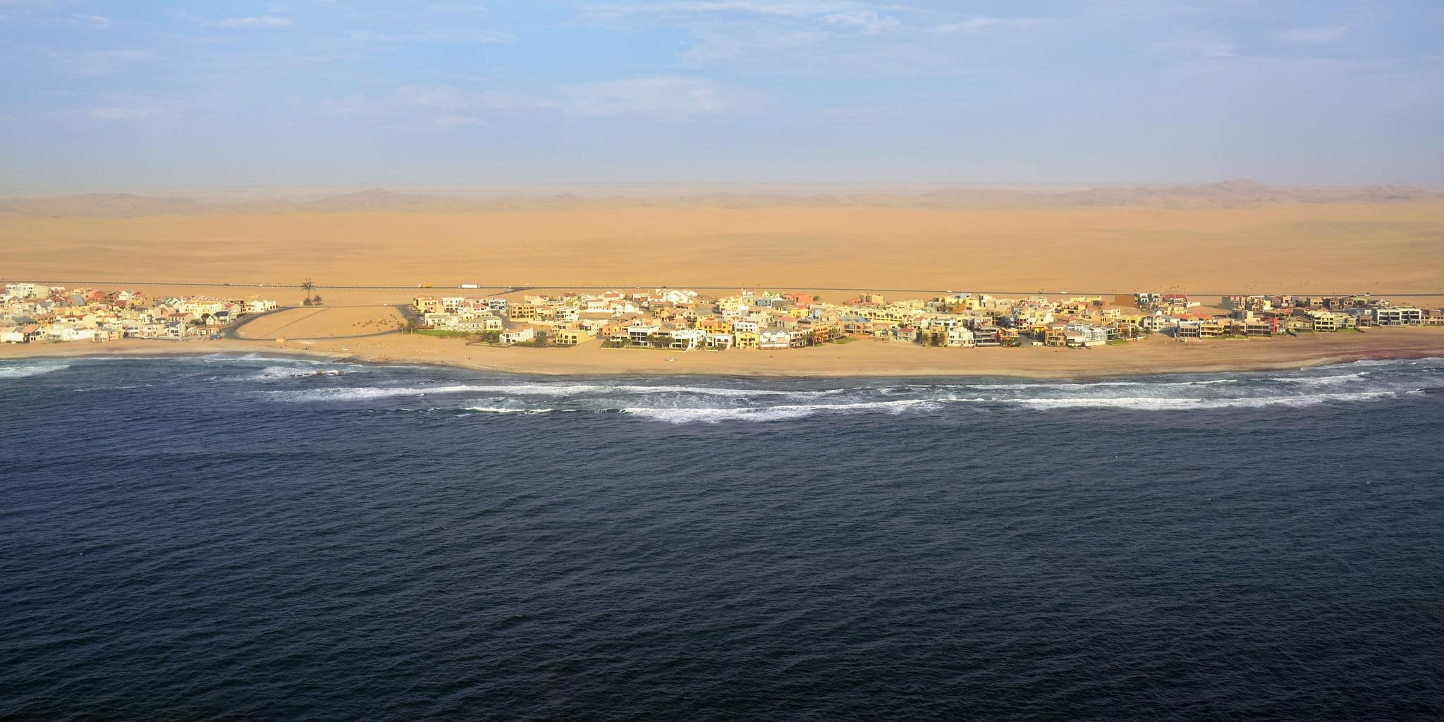 Aerial view on the coast in Namibia and modern districrt of the city Walvis Bay in the Namib desert, Atlantic ocean, Africa