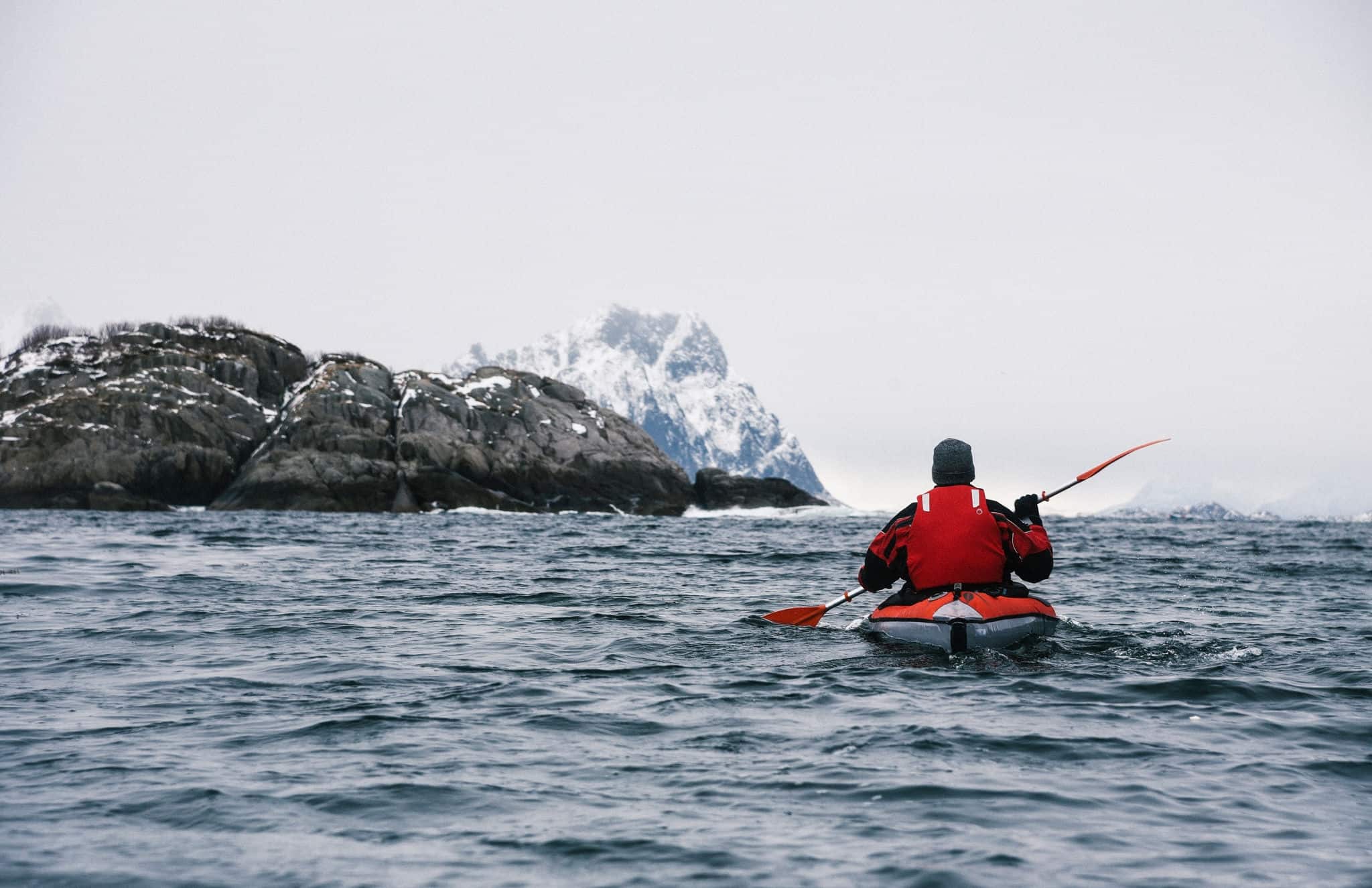 Winter Kayaking Along Coast of Lofoten Archipelago in the Arctic Circle in Norway