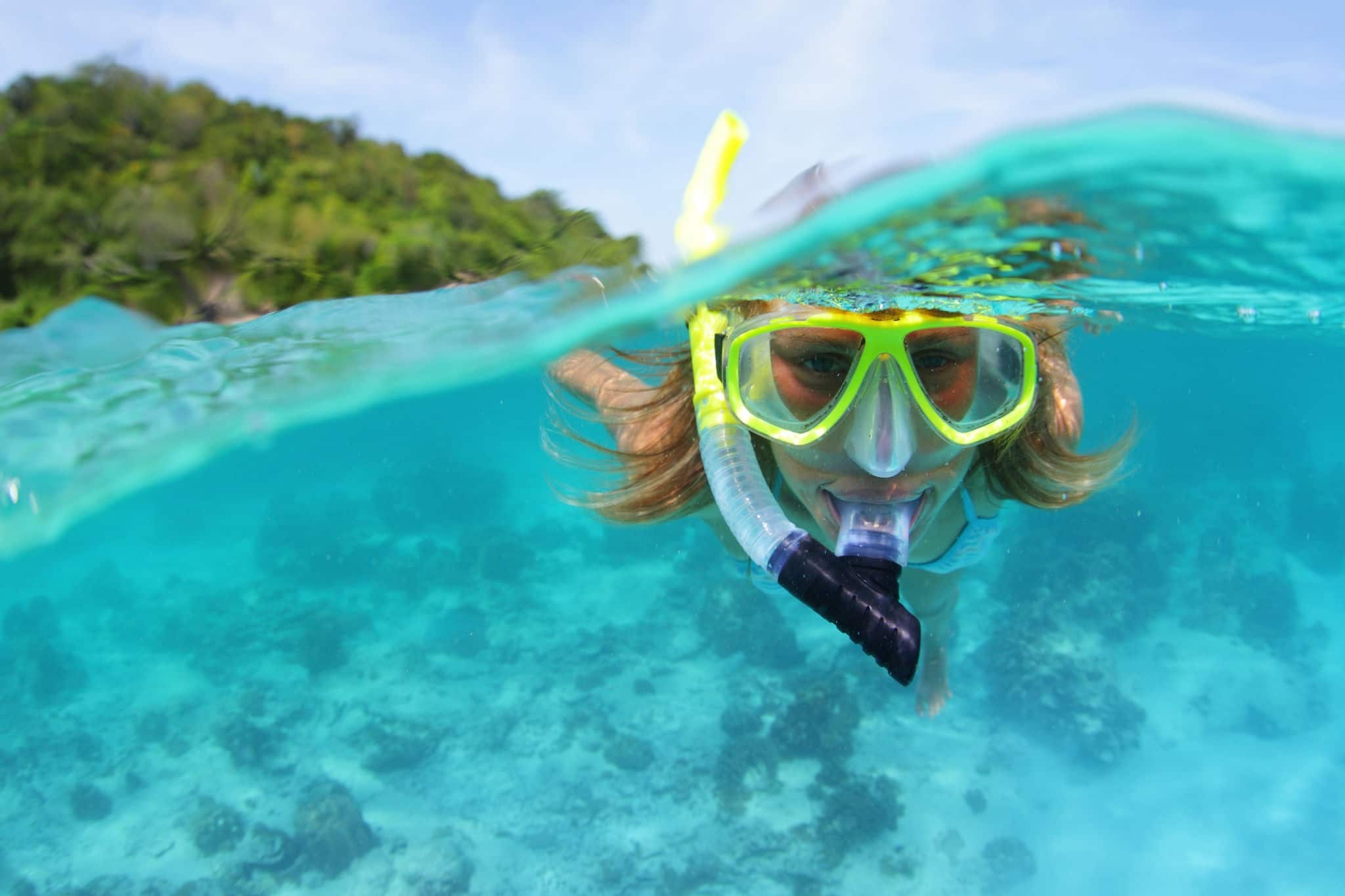 Underwater portrait of a woman snorkeling in tropical sea