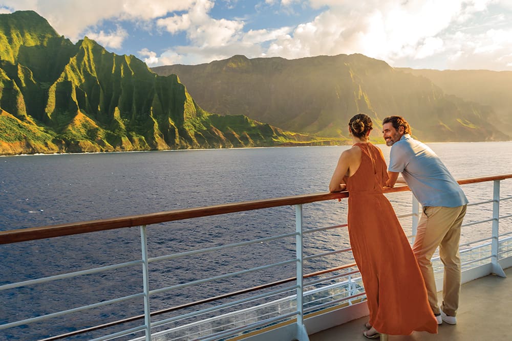 Couple watching the sunset on board a Norwegian cruise