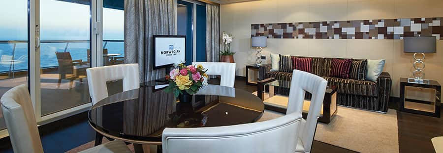 The Haven's Deluxe Owners Suite with Large Balcony Living Room on Norwegian Escape