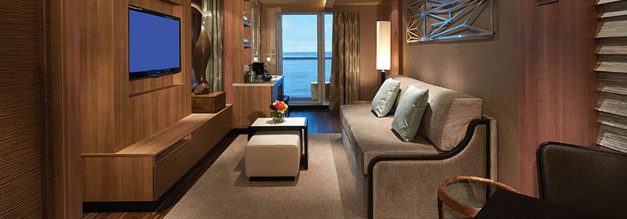 The Haven's Deluxe Spa Suite with Balcony living room on Norwegian Escape