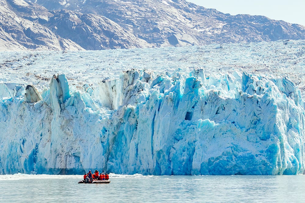 Ship Passengers on a Cruise Near a Glacier