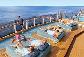 Multi-generational family enjoying time lounging on ship deck