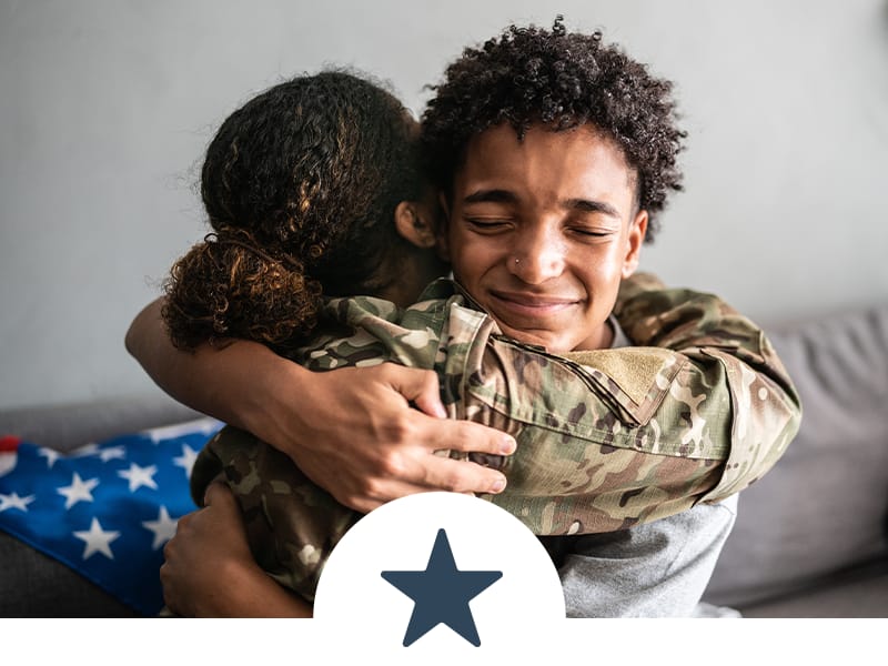 U.S Veteran spouse hugging and smiling