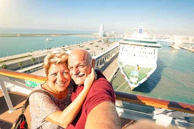 Game-loving couple playing photo scavenger hunt on their cruise ship vacation