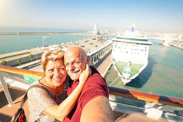 Game-loving couple playing photo scavenger hunt on their cruise ship holiday