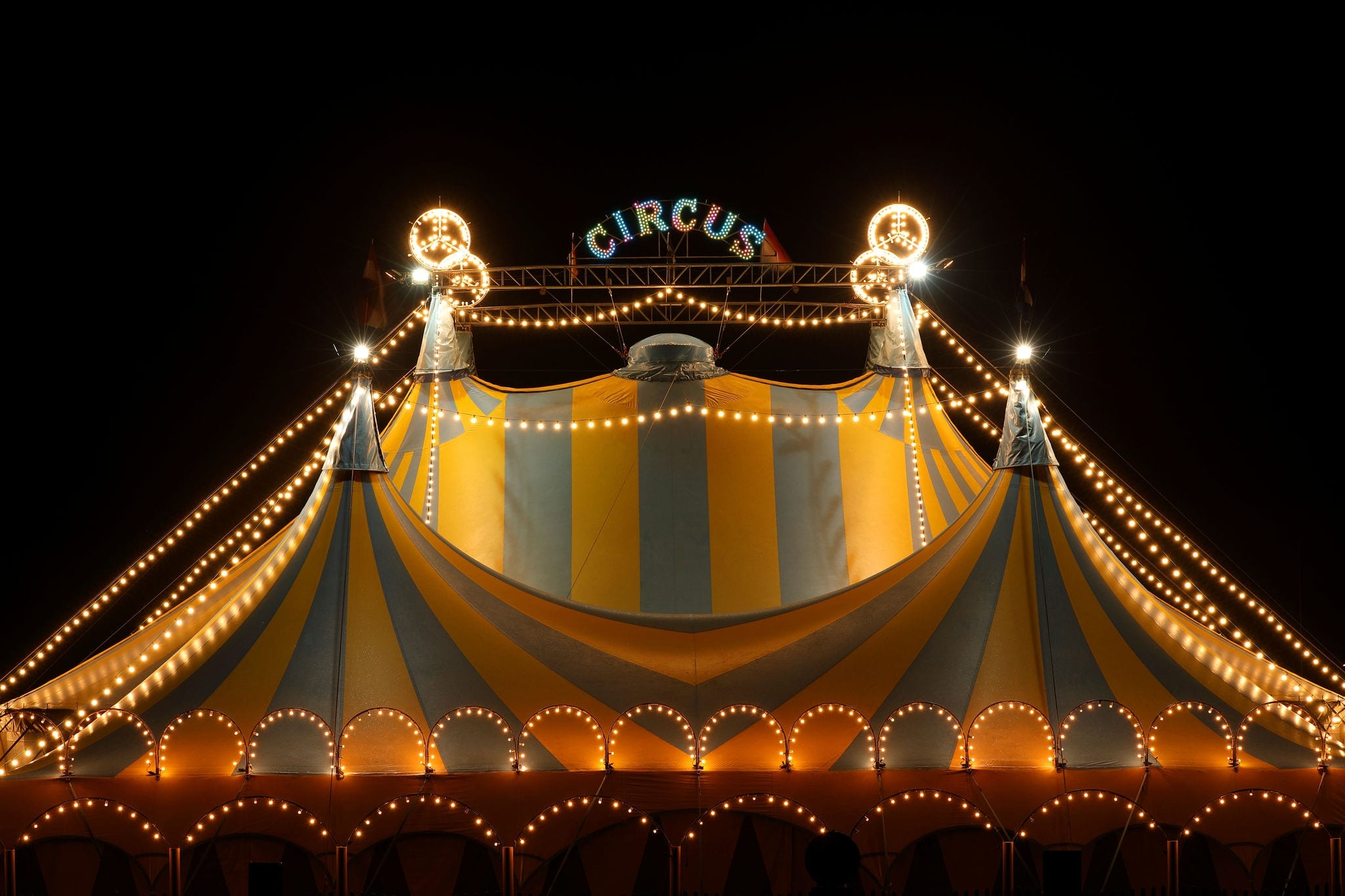 NCL-RhodeIsland-Newport-Cruise-FunFacts-Circus.jpg Circus tent at night with its colorful lights on