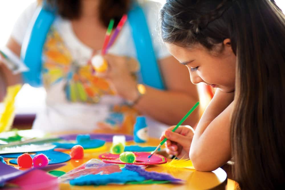 NCL-Aqua-Cruise-Activities-Splash-Academy Girl painting in Splash Academy