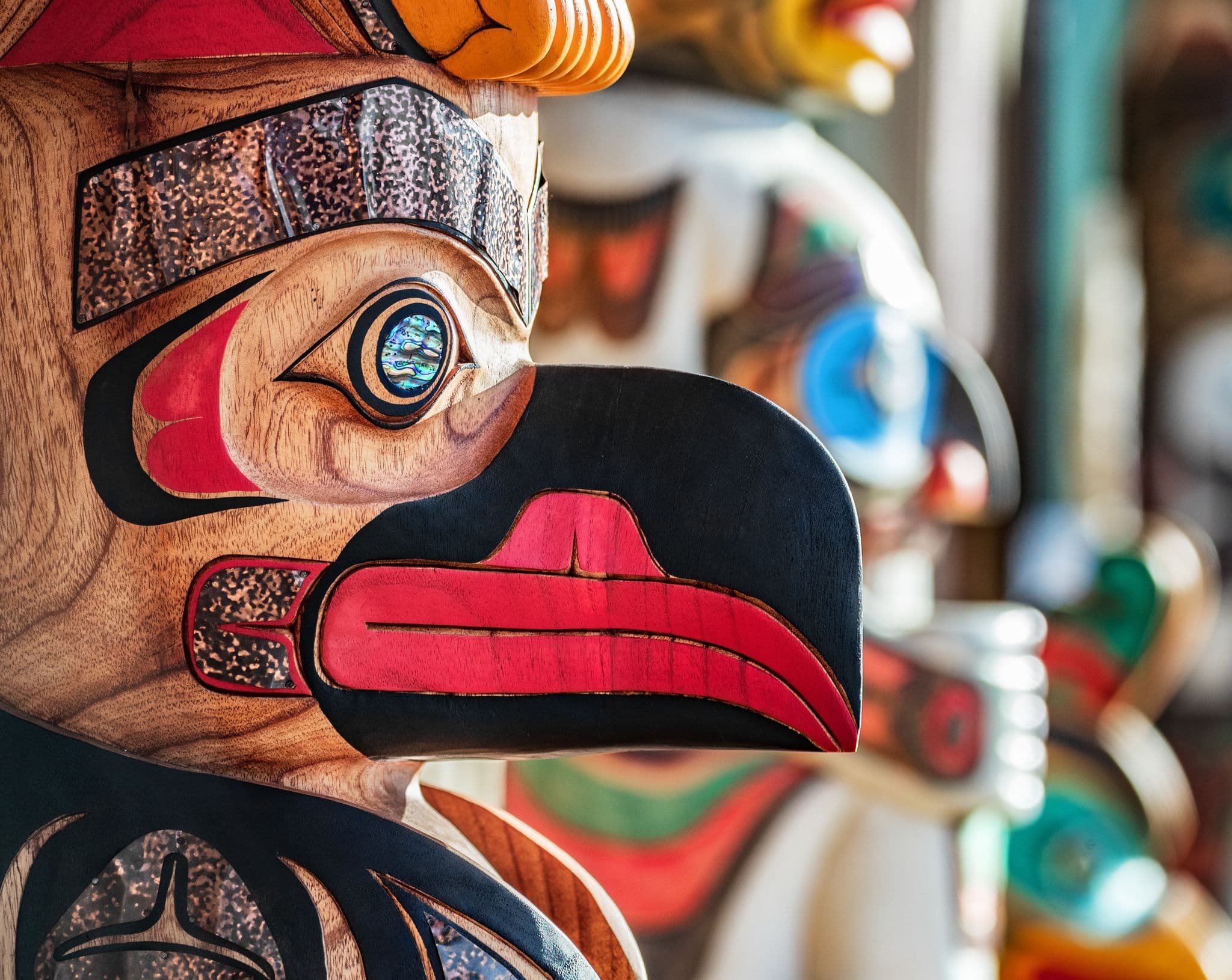 NCL-Alaska_Cruise-Juneau-Totem-Pole.jpg Alaska totem pole carving art sculture store in tourist travel attraction town on Alaska cruise. Ketchikan, Juneau, Skagway stores and shops selling native paintings and art. Closeup of an Eagle.