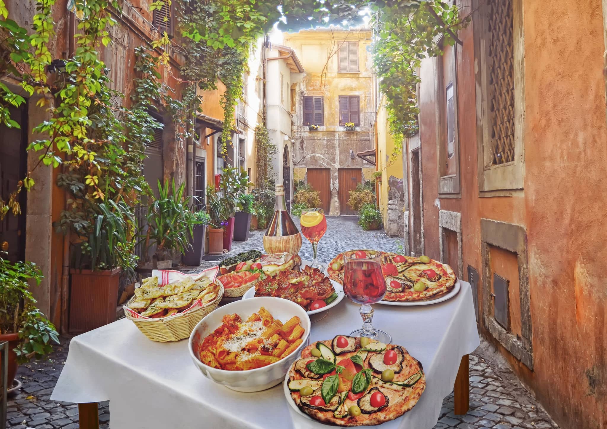 NCL-Italy_cruise-Rome_food.jpg A summer  dinner .Pasta , pizza  and homemade food arrangement  in a restaurant  Rome   .Tasty and authentic Italian food.